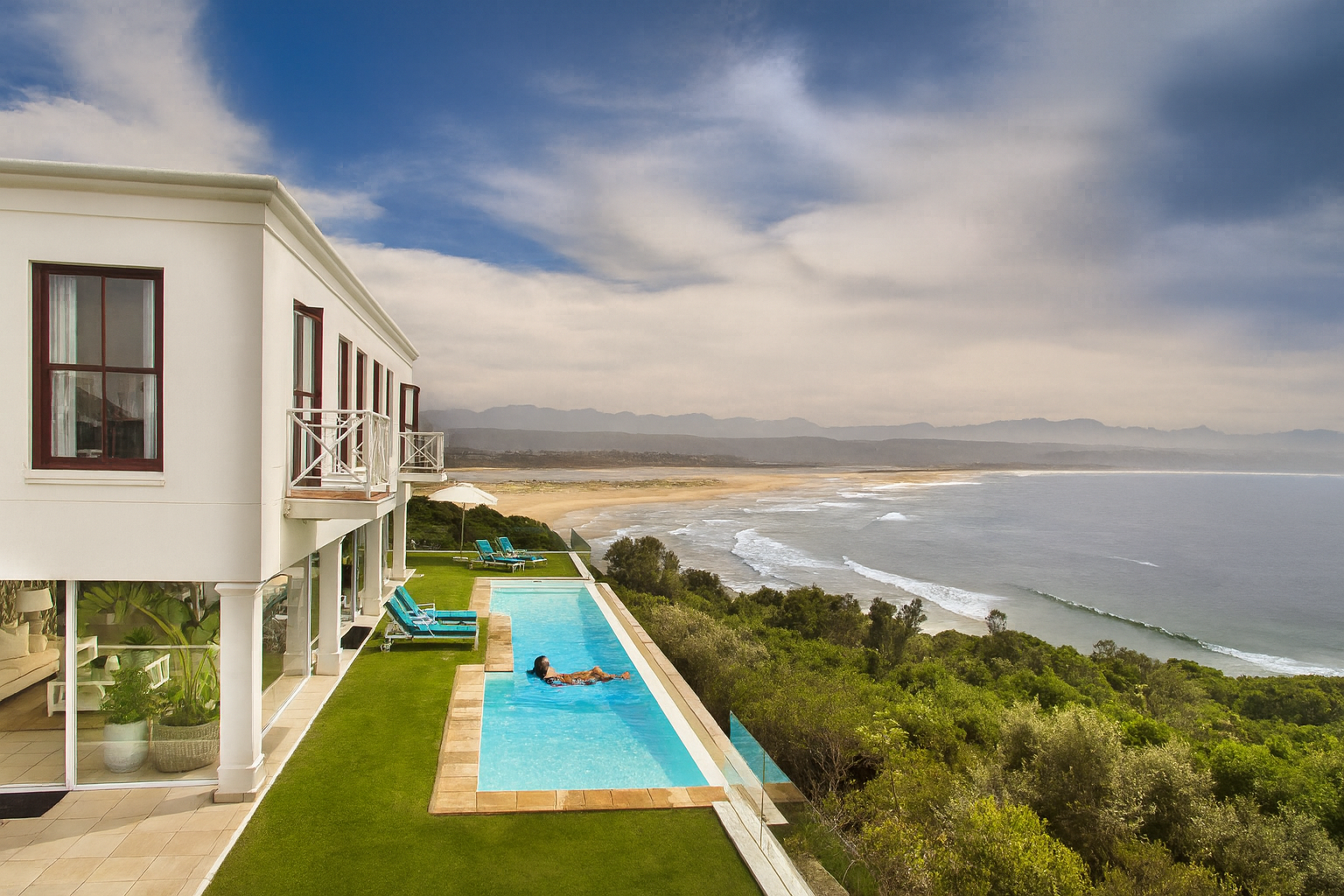 Infinity pool at The Plettenberg Hotel overlooking the ocean and beach.