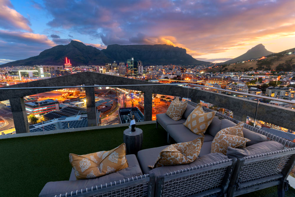 The rooftop lounge at The Silo Hotel at night, with views over Cape Town and Table Mountain.