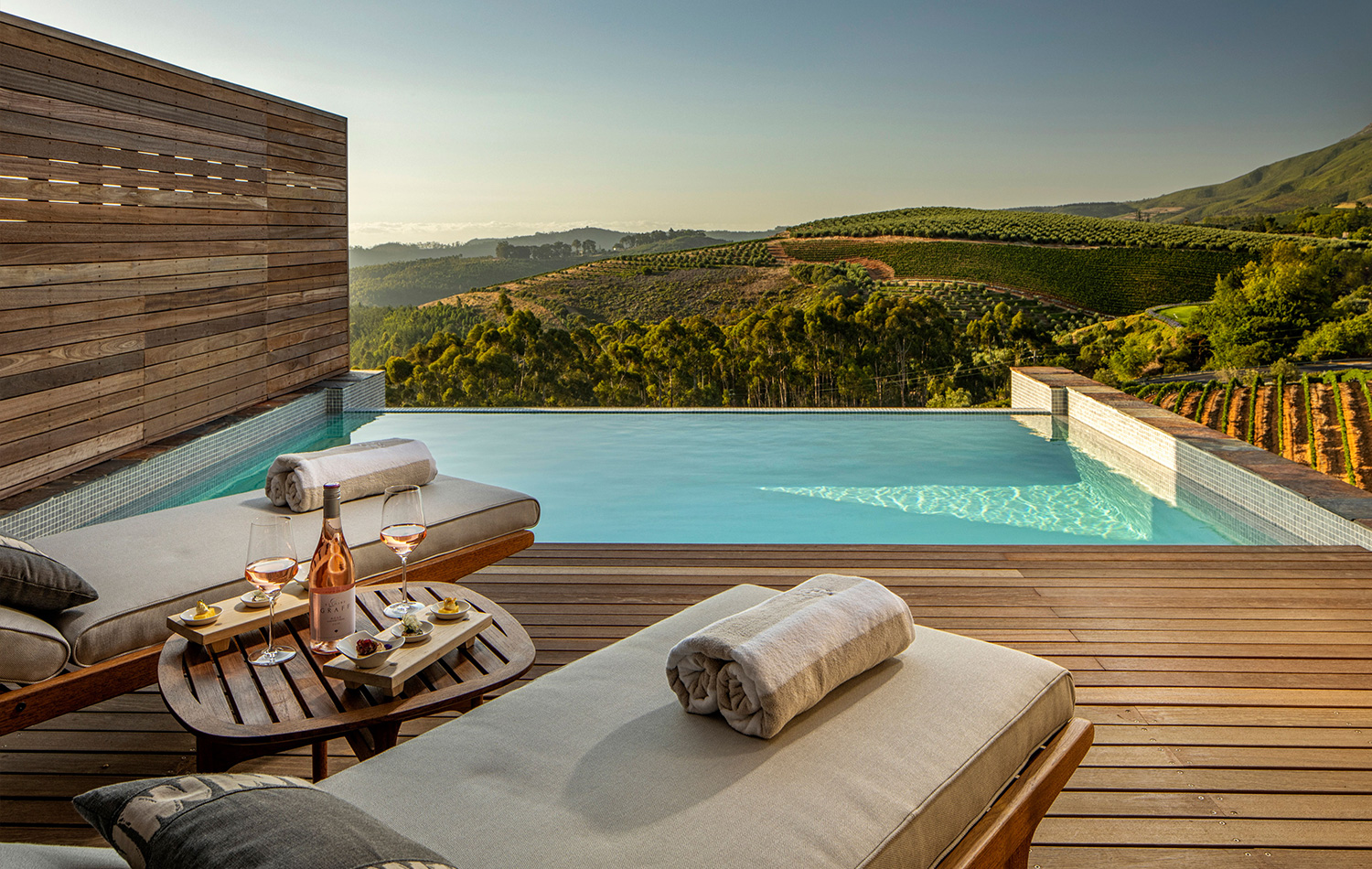 Private plunge pool on a wooden deck overlooking the vineyards at Delaire Graff Estate.